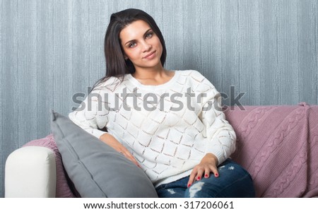 Relaxing at home, comfort. cute young woman smiling, relaxing  on white couch, sofa  at home.