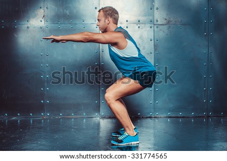 Sportsmen. fit male trainer man doing squats, concept fitness workout strenght power.