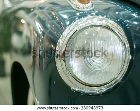 Detail on the headlight  lamp of a vintage retro classic car(Vintage effect style picture)