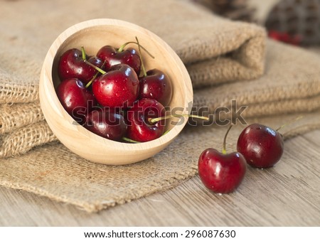Fresh  red cherries with water drops on wooden table