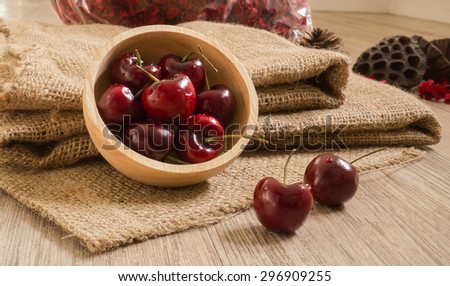 Fresh  red cherries with water drops on wooden table