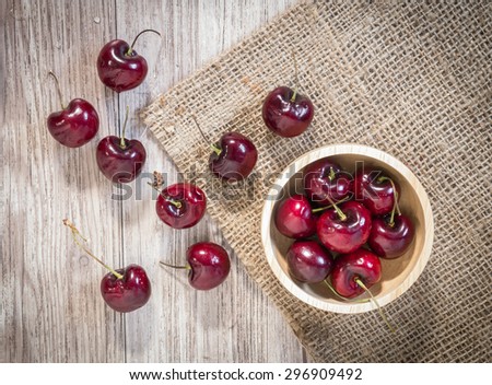 Top view of  Fresh red cherries with water drops on wooden table