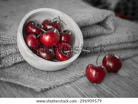 Fresh red cherries with water drops on wooden table