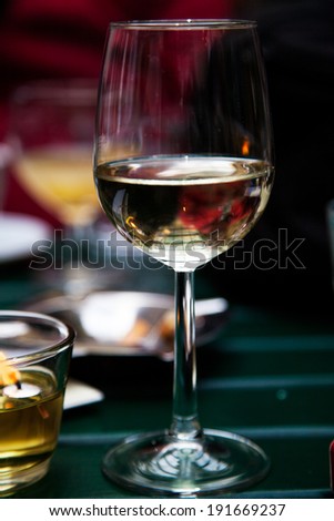 Glass of wine in cafe, with candle