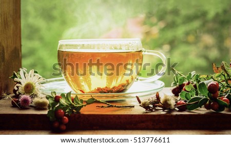 Cup of tea on the window sill. Hot tea. Tea leaves at the bottom of the cup. Delicious tea. Tea is waiting for ... It\'s tea time!