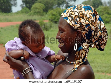 GEORGETOWN, GAMBIA - SEPT 12: Portrait of unidentified Mandinka woman with child, September 12, 2005 in Georgetown, Gambia. The major ethnic group in Gambia is Mandinka - 42% of the total population.