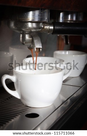 Espresso being drawn out of a professional espresso machine