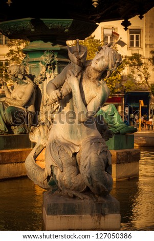 Mermaid sculpture. Fountain of Rossio Square at sunset of a summer day, Lisboa, Portugal