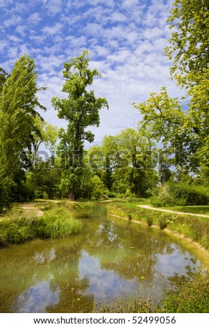 English garden and river in Marie-Antoinette\'s estate. Versailles Chateau. France