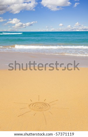 Sun shape written in the sand with seascape as background