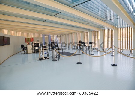 Security checkpoint in a building entrance hall with some x-ray metal detectors