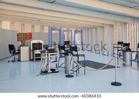 Security checkpoint in a building entrance hall with some x-ray metal detectors