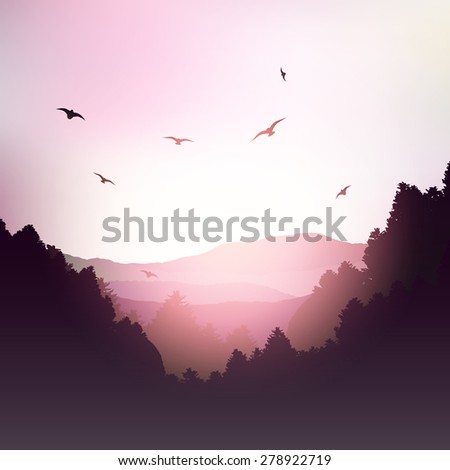 Landscape of mountains and trees against a sunset sky