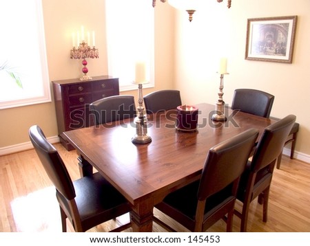 Dining Room with dark wood table, candelabra,chandelier,   two windows, natural wood floor.