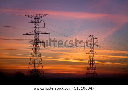 Power Lines And Electrical Towers In Silhouette Against A Vibrant Sunset Sky, Northern Ohio, USA