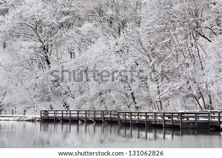 Snow Covered Trees, Path And Wooden Deck Along The Lake Shore During Winter In The Park, Sharon Woods, Southwestern Ohio, USA