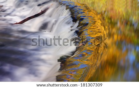Looking Like Tongues Of Fire, Autumn Leaves And Blue Sky Reflected In Calm River Water About To Plunge Over A Waterfall, Sharon Woods, Southwestern Ohio, USA
