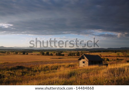 Late Evening Barn And Farm Scene In Vermont, Looking towards The Adirondack Mountains Of New York State.