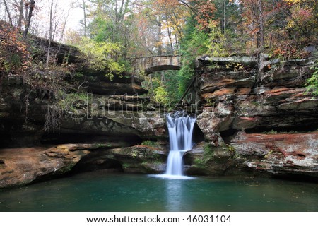 Waterfall And Stone Foot Bridge In The Scenic Old Man\'s Cave State Park Of Central Ohio, Hocking Hills Region In Autumn
