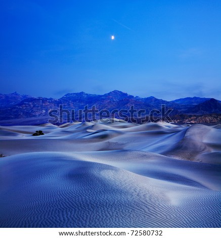 Sand Dunes, Mountains And Moonrise In The Predawn Light At Stovepipe Wells, Death Valley National Park, California, USA