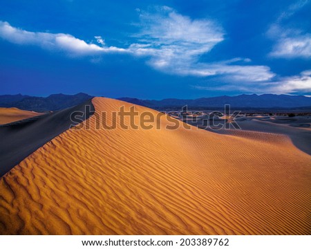Sand Dunes And Mountains In Early Morning Light At Stovepipe Wells In Death Valley National Park, California, USA