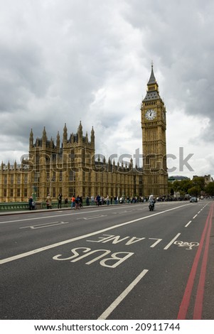 Houses of Parliament and Big Ben with detail of bus lane and moody sky
