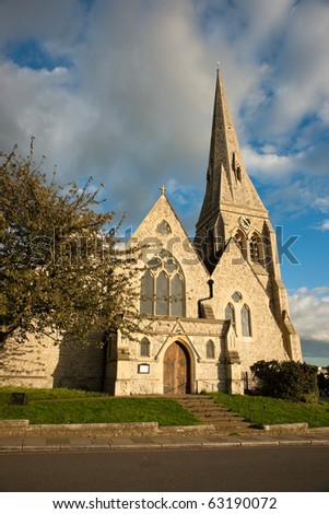 All Saints Parish Church, Blackheath, London, against moody cloudy sky