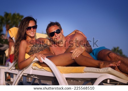 Picture of happy couple in sunglasses on the beach. love