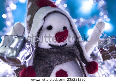 Snowman smiling brought Christmas gifts, turquoise background with flashing lights