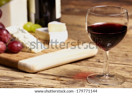 A red glass of wine and italian cheese