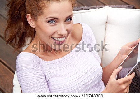young beautiful woman resting in a garden chair