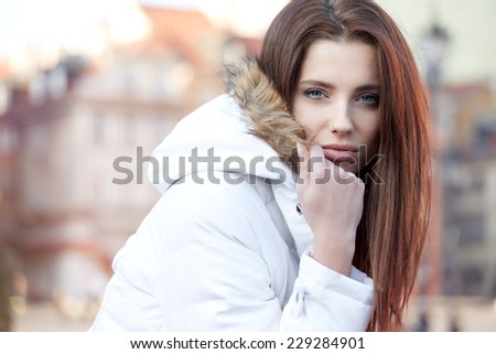 Portrait of the beautiful woman in winter jacket