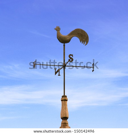 An Old Rooster Weather Vane with Blue Sky