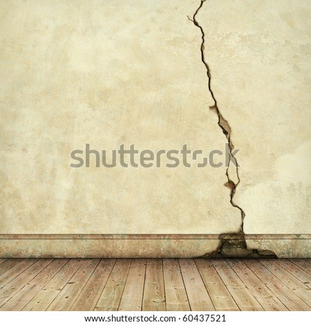 An Old Cracked Wall with wooden Floorboards