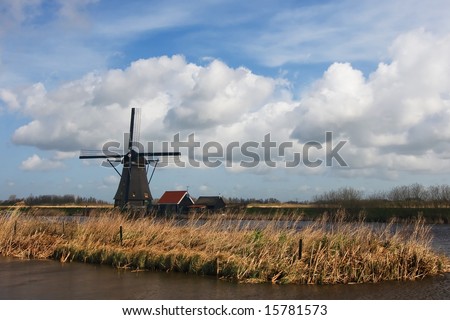 Dutch windmill on a cloudy Spring afternoon in a typically Dutch landscape
