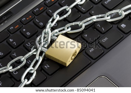 Closeup of a keyboard with chains and a lock, representing the concept of computer security.