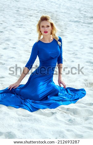 Affective vivid beautiful model in blue dress in the desert