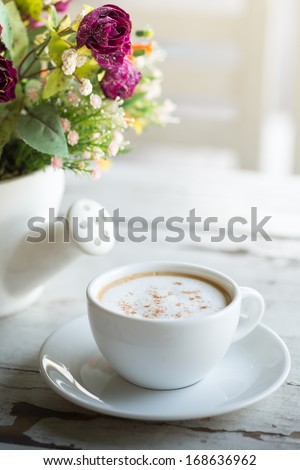 Cup of coffee with flowers