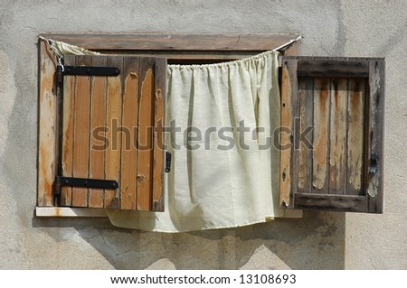 wooden shutters and curtain on wall