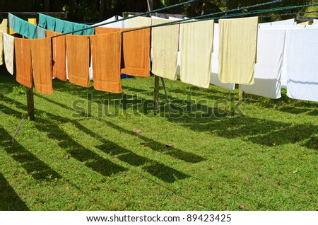 fresh clean hotel towels drying on a line outdoors