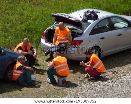 Most, Czech Republic - MAY 14, 2014: Road workers repairing tram rails having a rest.