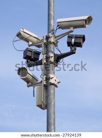 stock-photo-a-post-full-of-surveillance-cameras-27924139.jpg