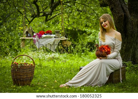 Girl in the garden with a basket of flowers