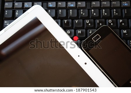 Black keyboard,smartphone and white tablet PC
