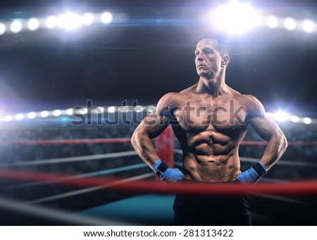 A strong man in the ring in blue boxing bandages preparing for battle