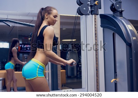 young sexy girl in a sports gym shorts and T-shirt for sports