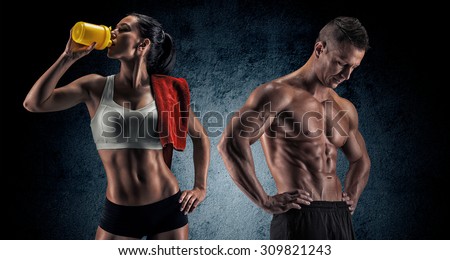 Bodybuilding. Strong man and a woman posing on a dark background