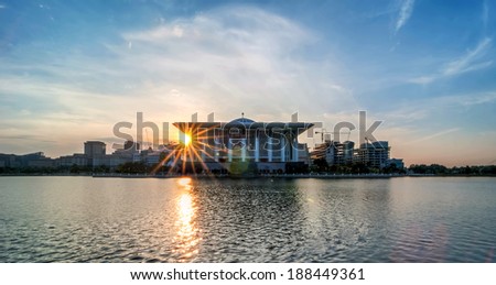 Beautiful mosque with reflection in Putrajaya, Malaysia by the lakeside during sunrise