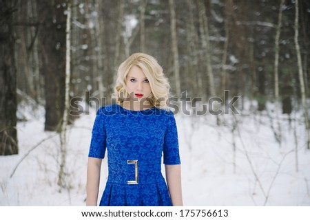 pretty woman in a blue dress in the forest