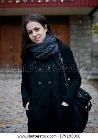 brunette college student after her classes winter portrait outdoor